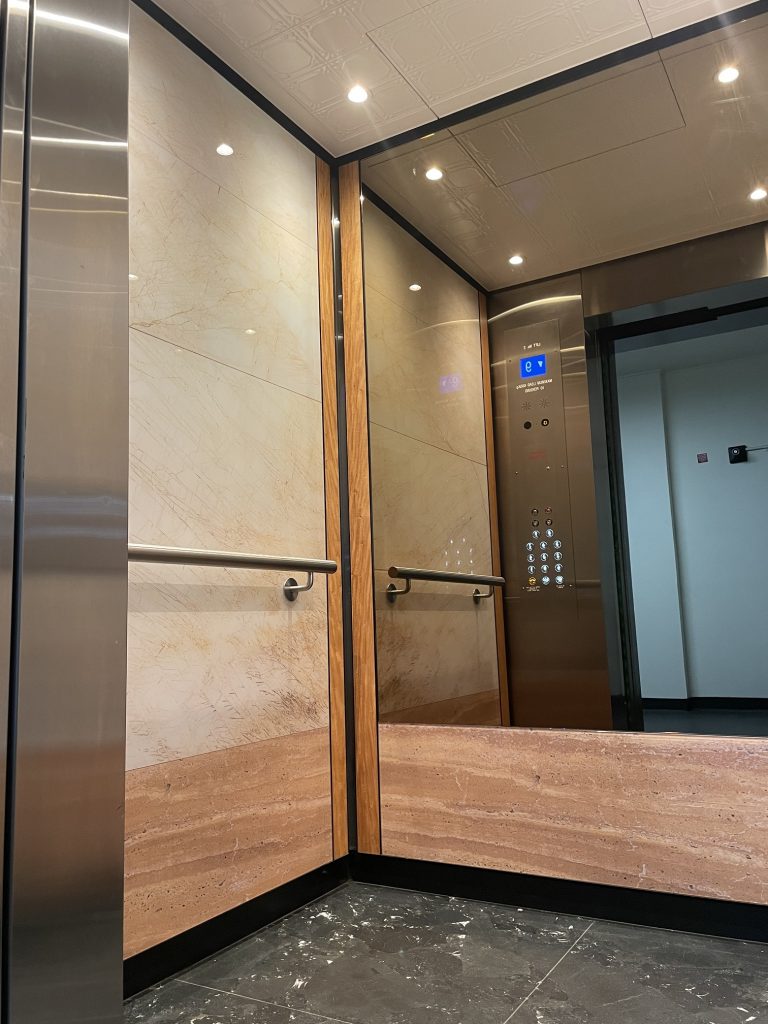 Electra Lift Interior, marble image colour back glass, modern lift interior