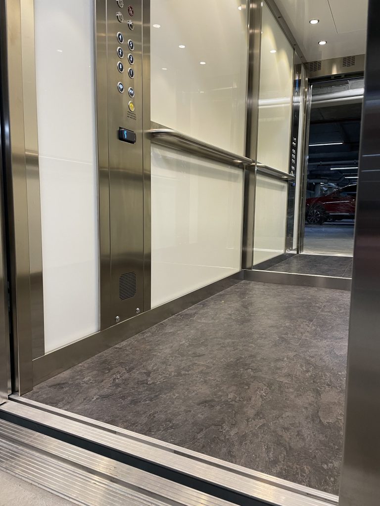 white glass lift interior, MRL installation