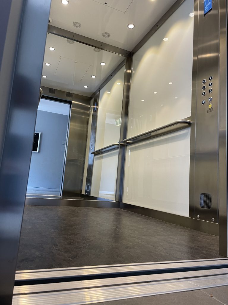 White glass interior, MRL lift interior, lift company
